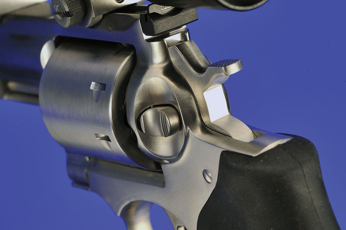 This Ruger has the familiar appearance designed into its smaller-framed guns. The cylinder release pushes in to release the cylinder; the hammer is serrated and clears the scope for easy cocking.
